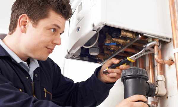 male plumber working on central heating