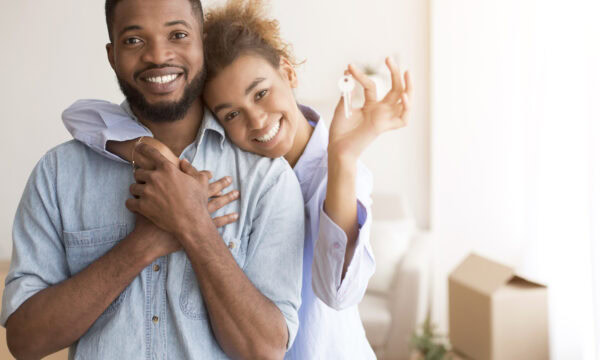 Couple Holding New Home Key Hugging Standing In Own House