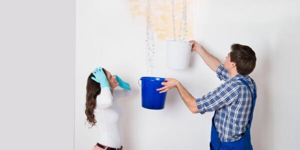 woman with worker collecting water